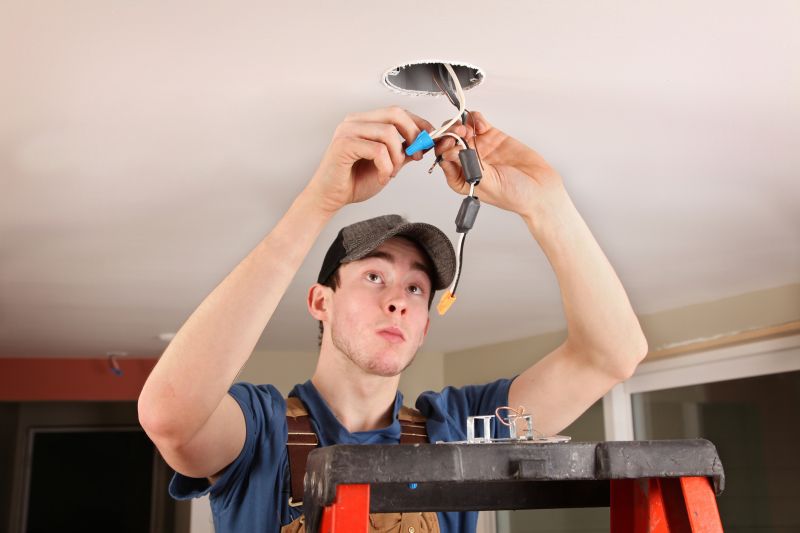 Handyman installing a light fixture